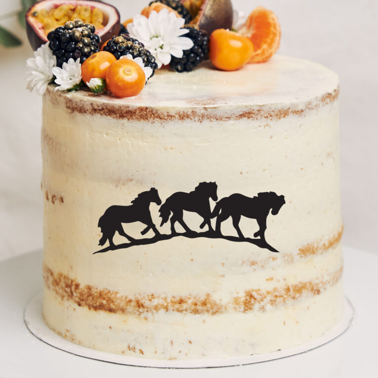 White cake with berries and passionfruits next to a plant behind a white background